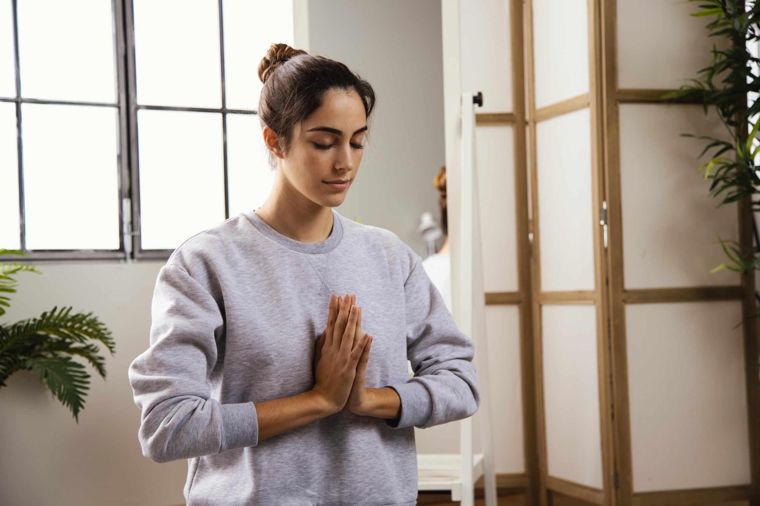 front-view-young-woman-doing-yoga-home